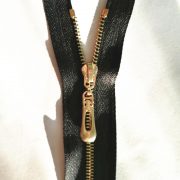 No.5 zipper with light gold teeth and  auto lock slider